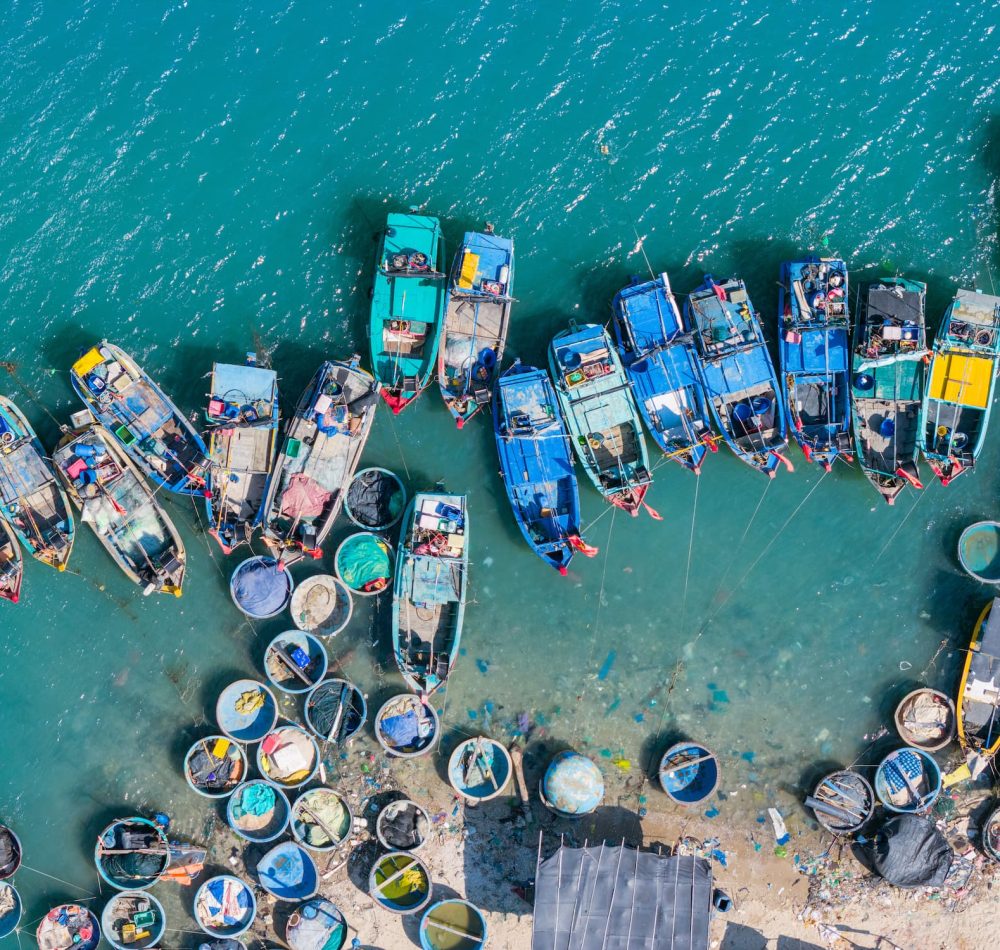 aerial-view-loc-fishing-village-vung-tau-city-fishing-port-with-tsunami-protection-concrete-blocks-cityscape-traditional-boats-sea